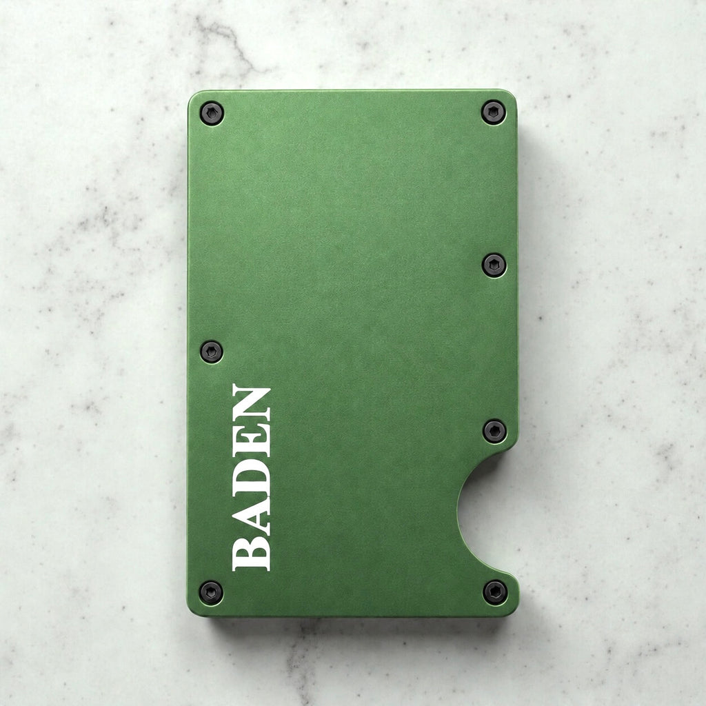 Personalised green metal card holder with engraved name on a marble surface