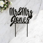 Personalised laser-cut wedding cake topper with custom surname with heart and in black Acrylic