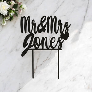 Personalised laser-cut wedding cake topper with custom surname with heart and in black Acrylic