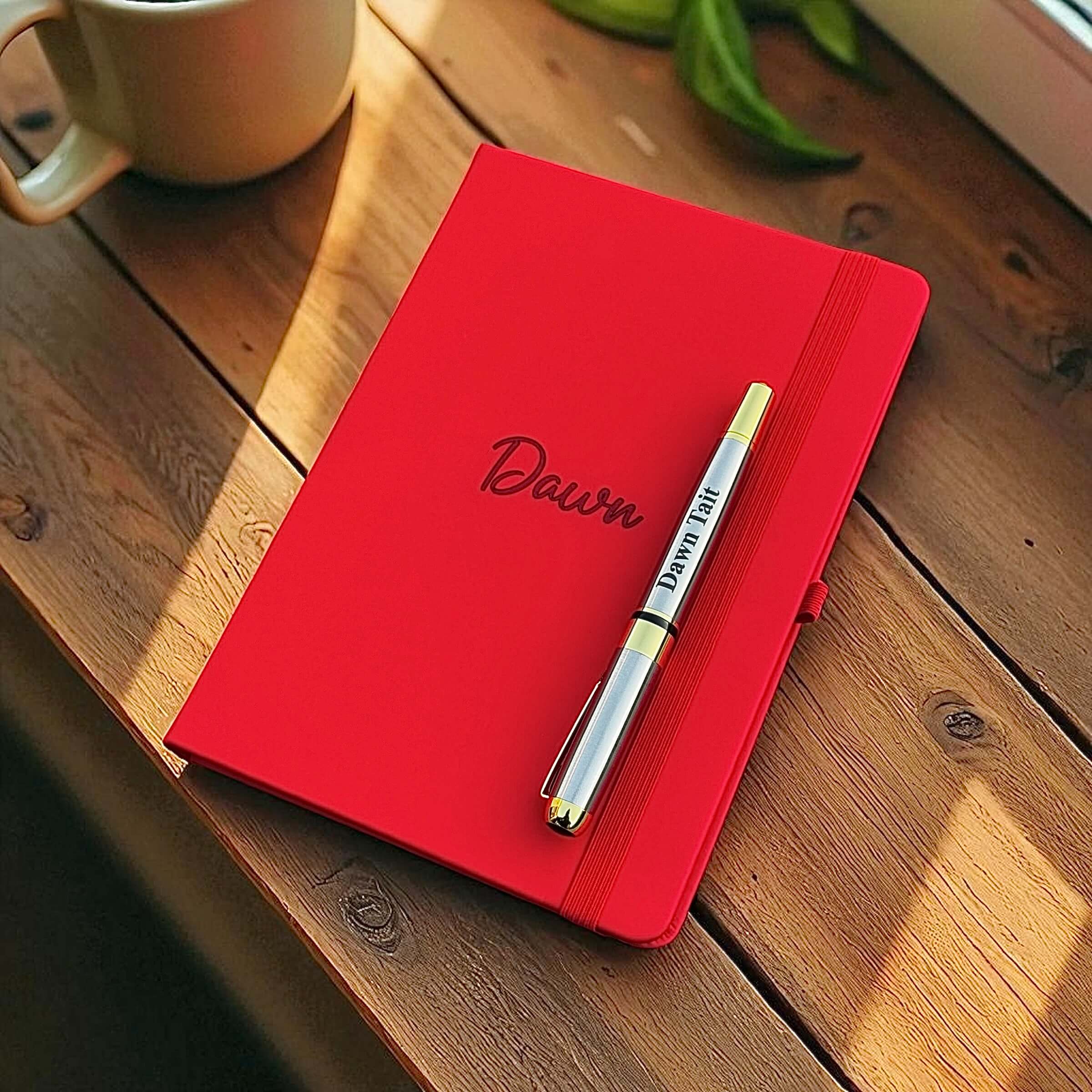 Personalised leather journal and pen set placed by a coffee cup, ready for writing