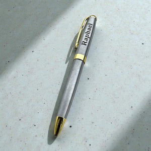 Personalised silver ballpoint pen engraved with Raphael and finished with gold trim