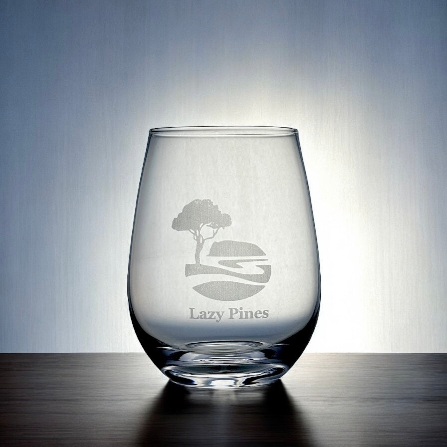 Personalised stemless wine glass with engraved business logo and name on wooden surface