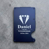 Personalised wedding party metal card holder engraved with Daniel, Groomsman and date on a romantic wedding flat lay