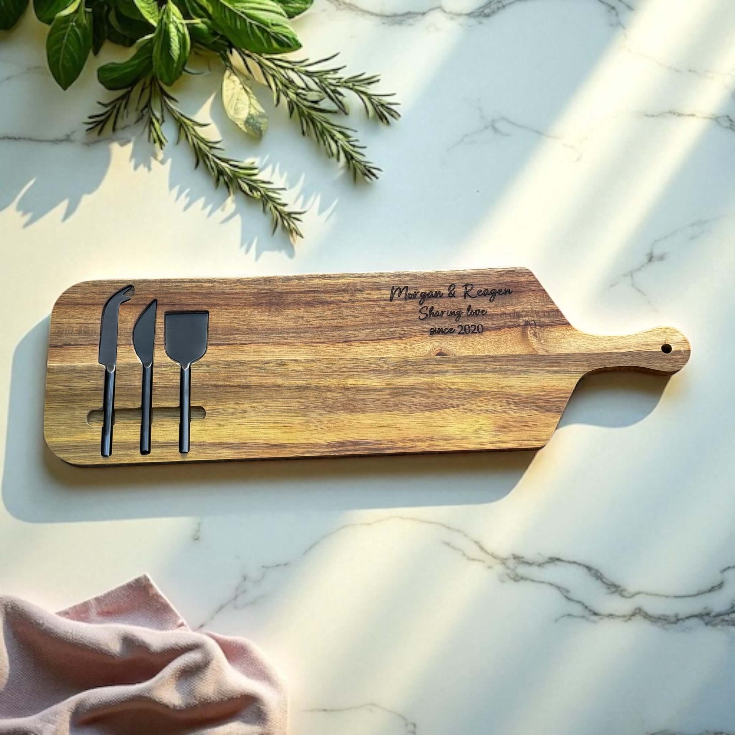 Personalised wooden cheese board with engraved couple's names and date, perfect for weddings or anniversaries.