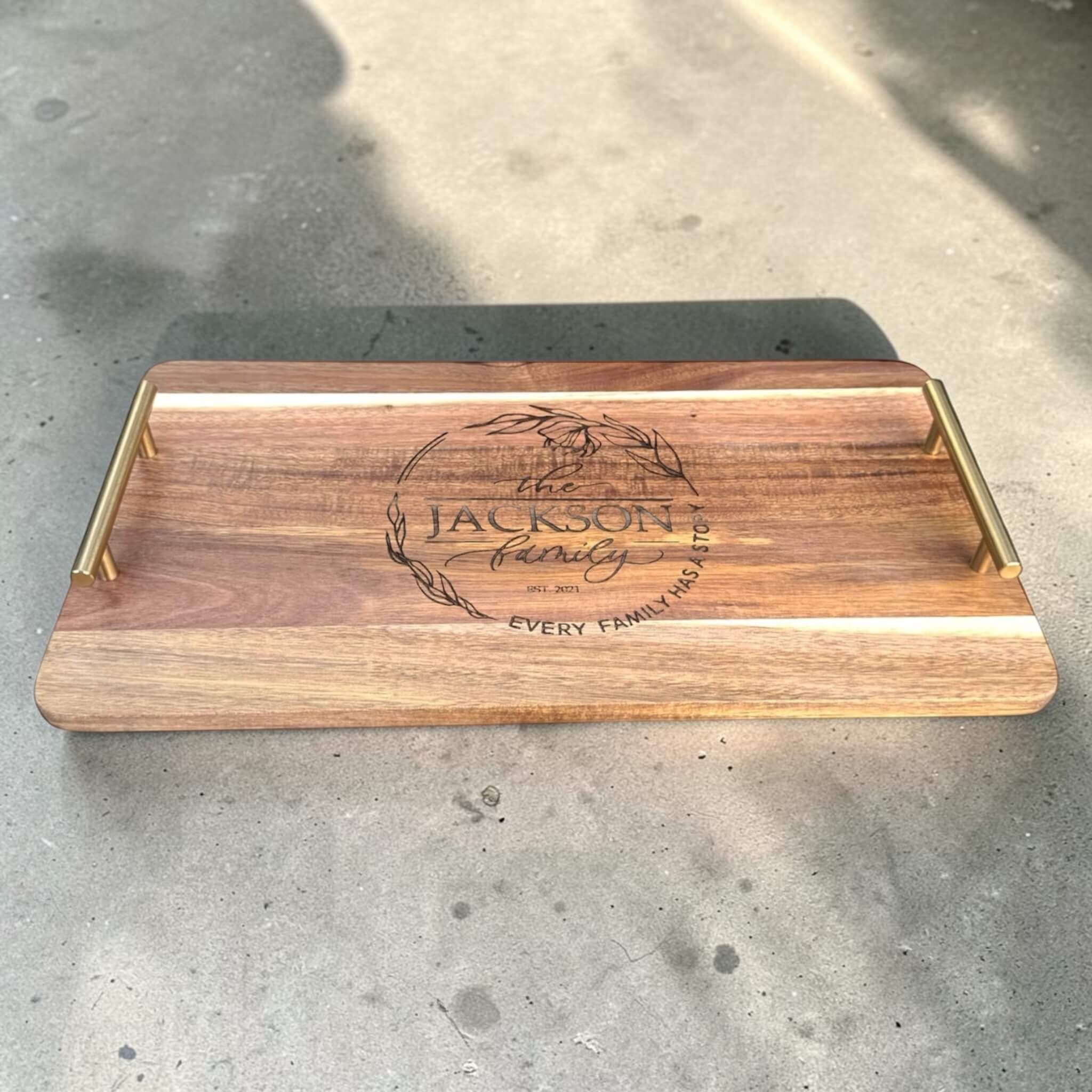 Personalised wooden serving board with brass handles engraved with family name wreath design, custom laser engraved platter perfect for wedding or anniversary gift NZ