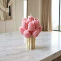 Pink tulip bouquet shaped soy wax candle on marble surface, decorative floral pillar candle with cream stems, luxury home decor gift