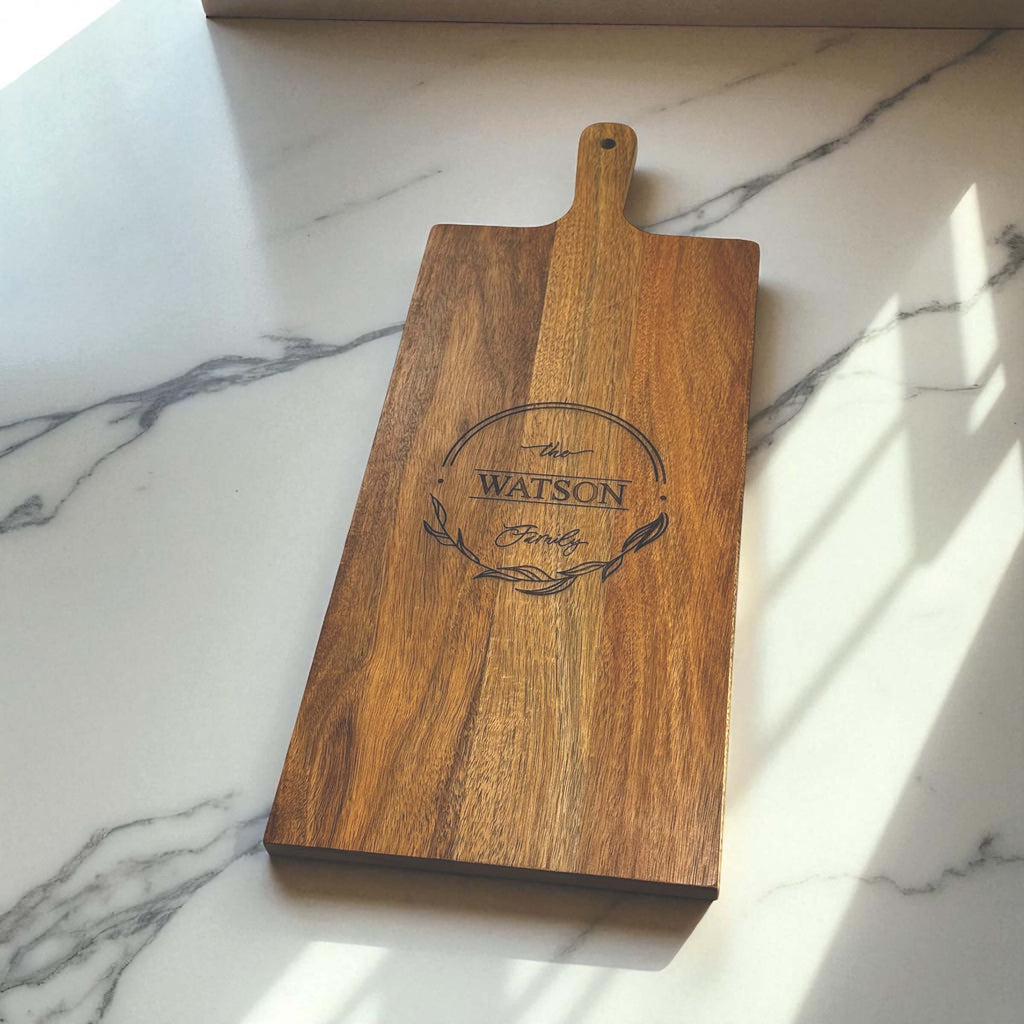 Rectangle acacia serving board with engraved family name on marble-look surface