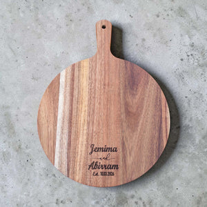 Round acacia serving board engraved with Jemima and Abirram wedding date