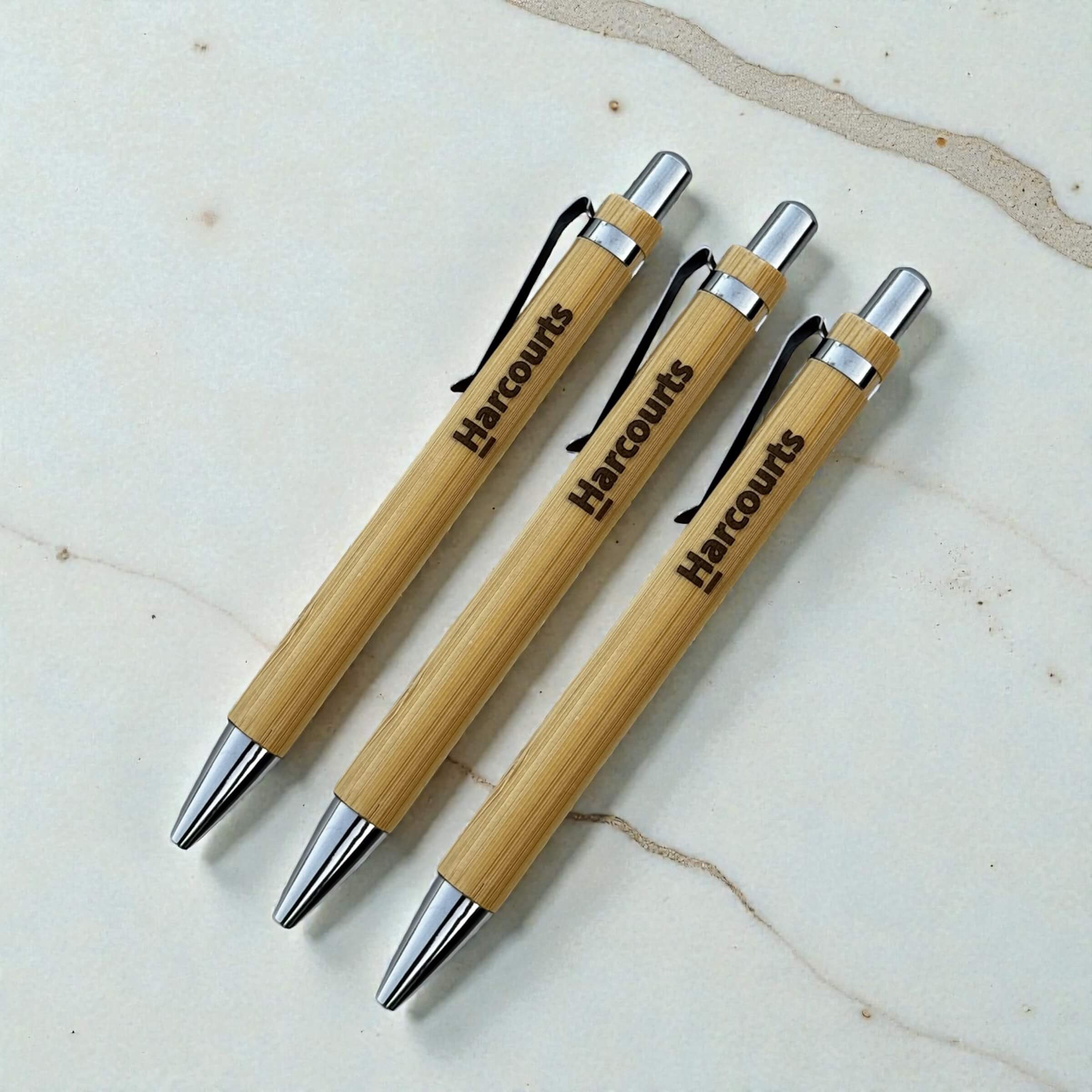 Set of three branded bamboo pens with Harcourts engraving, corporate promotional pens with silver fittings, bulk order