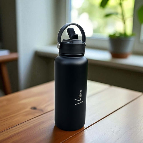 Side angle of personalised stainless steel water bottle showing engraved name detail and sturdy powder coated finish.