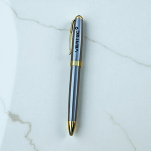 Silver and gold pen with 'Vertec' branding on a marble surface