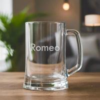 Simple engraved beer mug featuring name Romeo, personalised glass gift on wooden table in modern living room setting