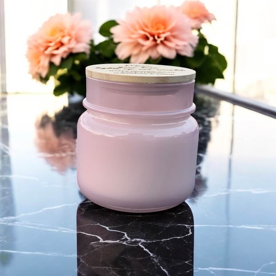 Soft glass candle with engraved wood lid, styled with flowers in the background