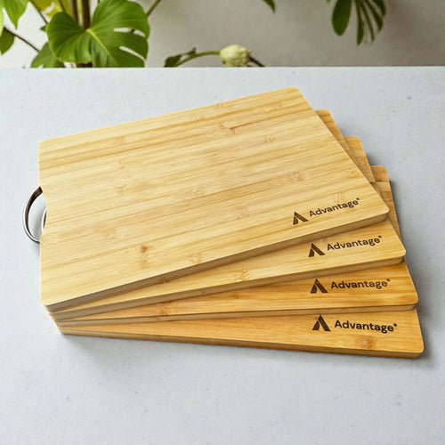 Stack of four laser engraved bamboo chopping boards with corporate logo, bulk branded business gifts with stainless steel handle