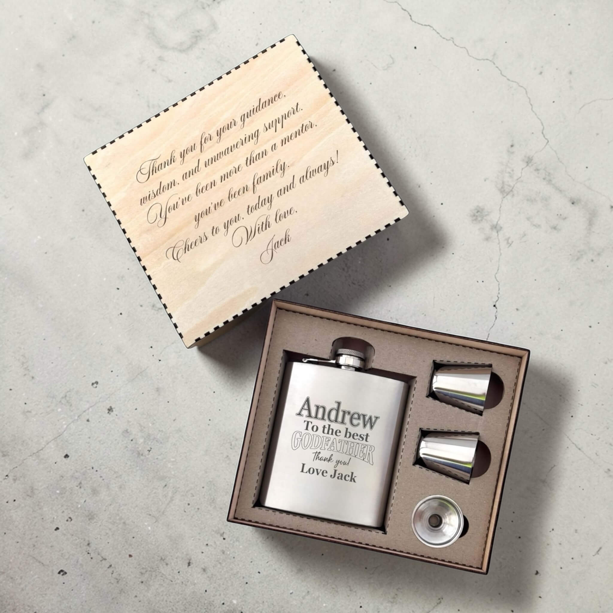 Stainless steel flask set with personalised message for godfather in a box on a concrete surface