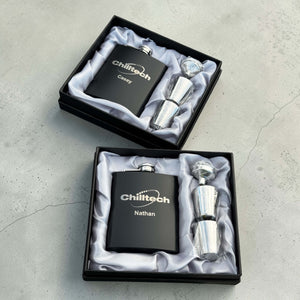 Two personalised corporate hip flask gift sets in black presentation boxes with shot glasses, custom engraved branded staff gifts