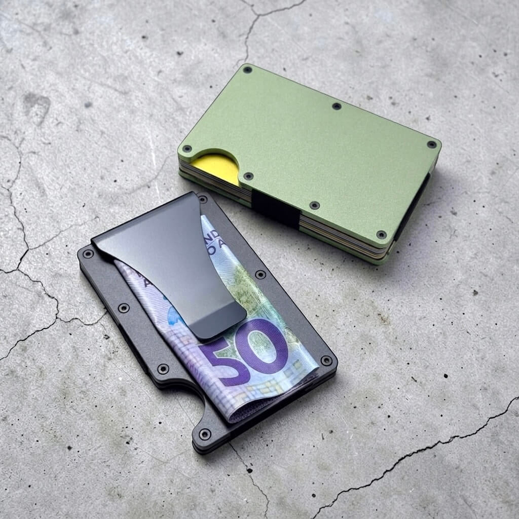 Two slim aluminium RFID card holders with money clip showing cash and cards, personalised metal wallet in green and black