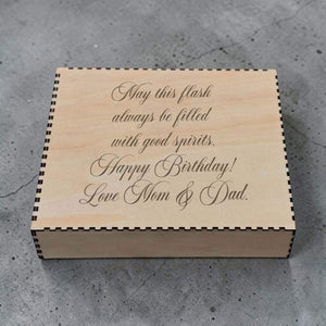Wooden box with engraved birthday message from Mom & Dad on a concrete surface