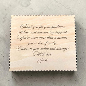Wooden box with engraved message for godfather on a textured surface