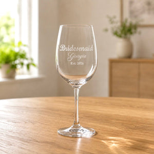 Clear wine glass with frosted bridesmaid Georgia engraving on wooden table