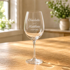 Close up personalised wedding wine glass with names and date engraving