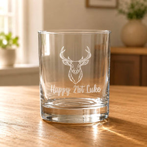 Engraved 21st birthday stag whiskey glass with Happy 21st Luke personalisation on wooden table