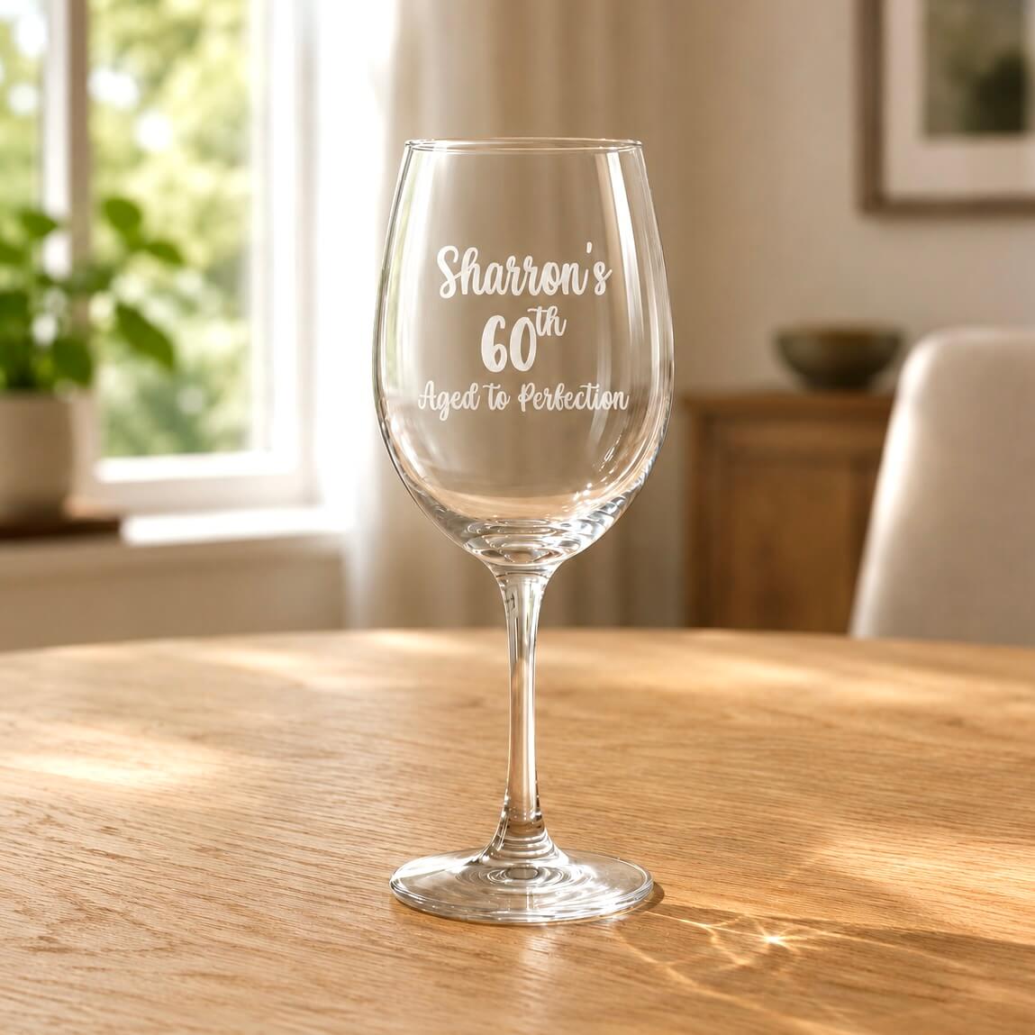 Engraved 60th birthday wine glass with name and aged to perfection message