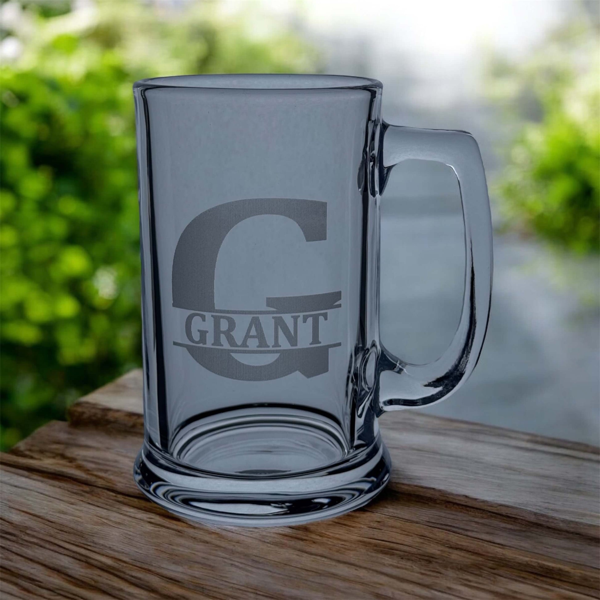 engraved beer glass in split initial on table
