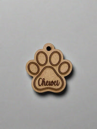 engraved wooden dog id tag in dog paw shape with name