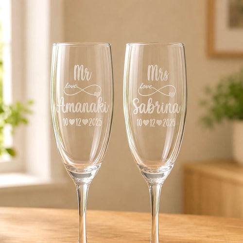 Close-up of personalised champagne flutes with frosted infinity heart and Mr and Mrs engraving