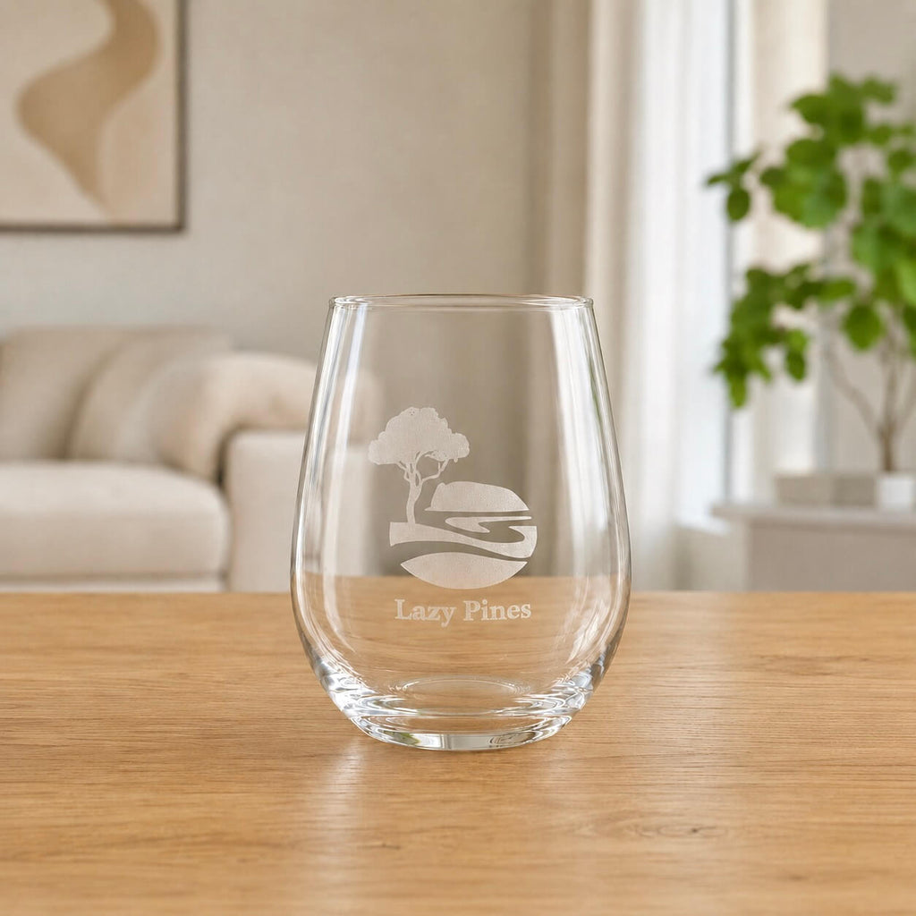 Personalised stemless wine glass with frosted business logo in bright home setting